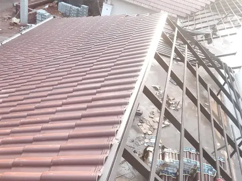 Ceramic tiles being laid on a steel frame